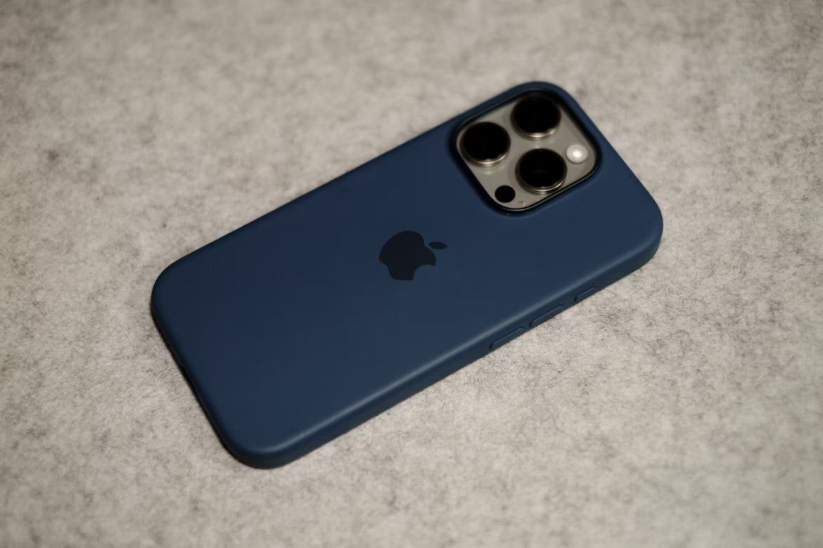 iPhone 16 Pro in a navy blue silicone case with MagSafe compatibility